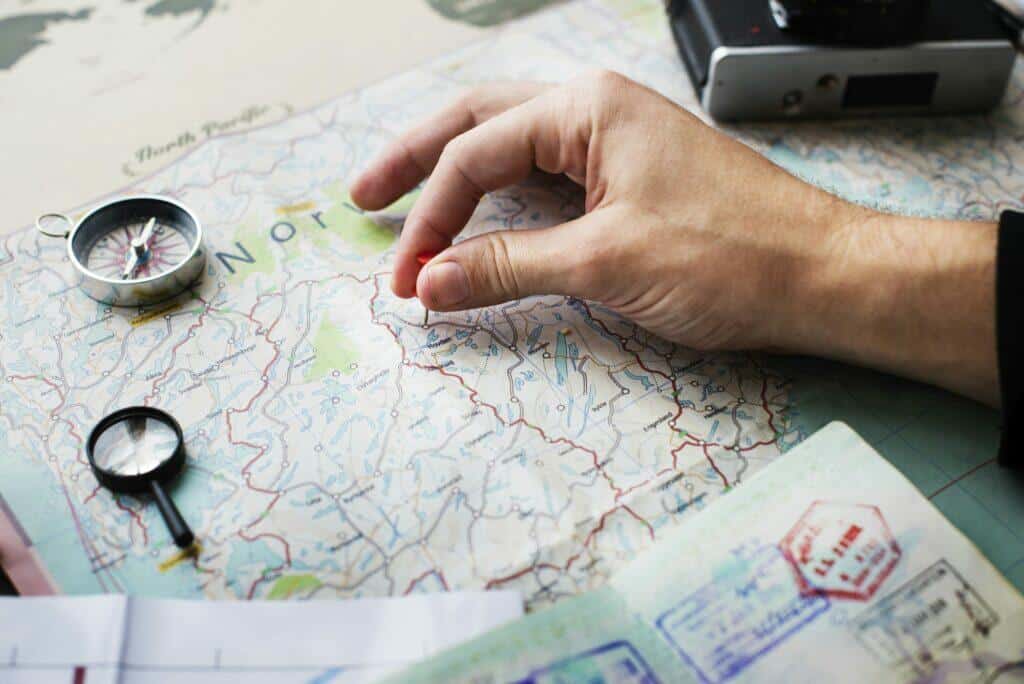 Closeup of hand pinning on world map journey travel