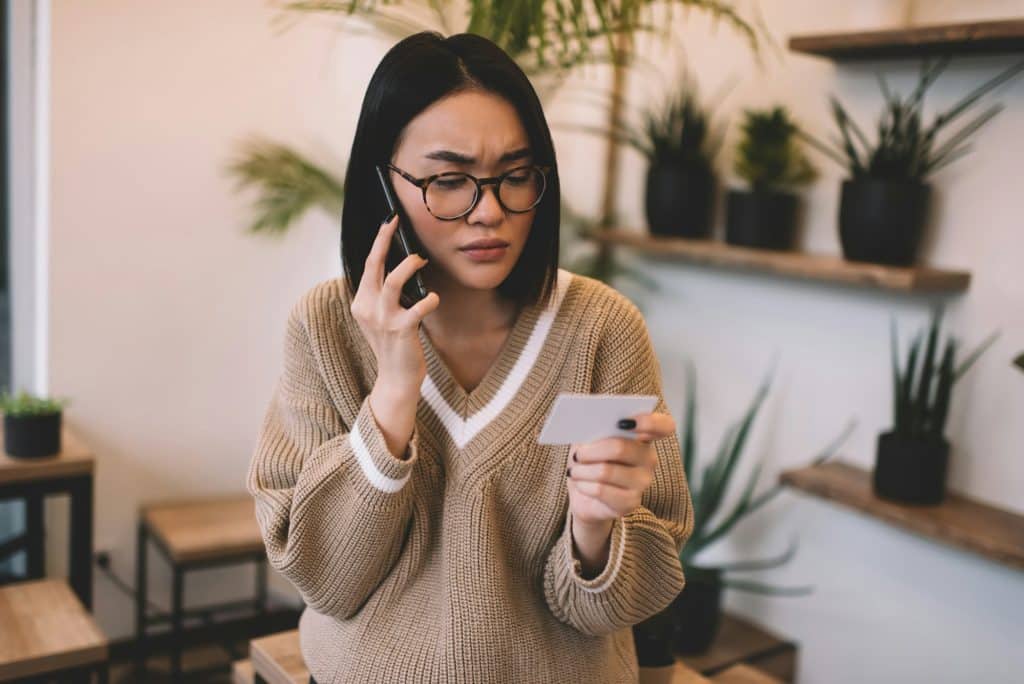 Girl with digital virtual business card talking on smartphone